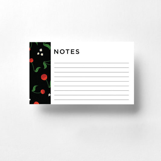 These notecards feature a charming cherry design set against a sleek black background. The bright red cherries pop vividly, creating a striking and playful contrast. Ideal for personal notes, reminders, or thoughtful messages, these notecards add a touch of whimsy and elegance to your correspondence.