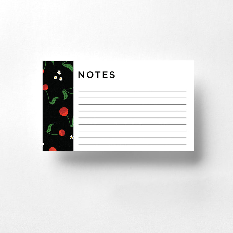 These notecards feature a charming cherry design set against a sleek black background. The bright red cherries pop vividly, creating a striking and playful contrast. Ideal for personal notes, reminders, or thoughtful messages, these notecards add a touch of whimsy and elegance to your correspondence.