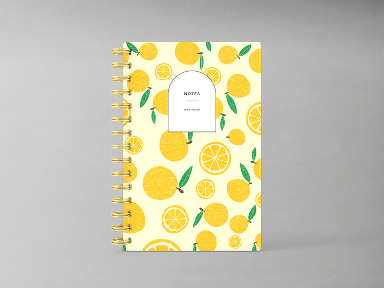 Discover a refreshing addition to your stationery collection with this A5-sized hardcover spiral bound notebook, featuring a delightful lemon design against a light yellow background. Enhanced by a sturdy spiral in complementary gold, its interior offers blank pages ready for your thoughts, sketches, or plans, combining style and functionality in one chic package.